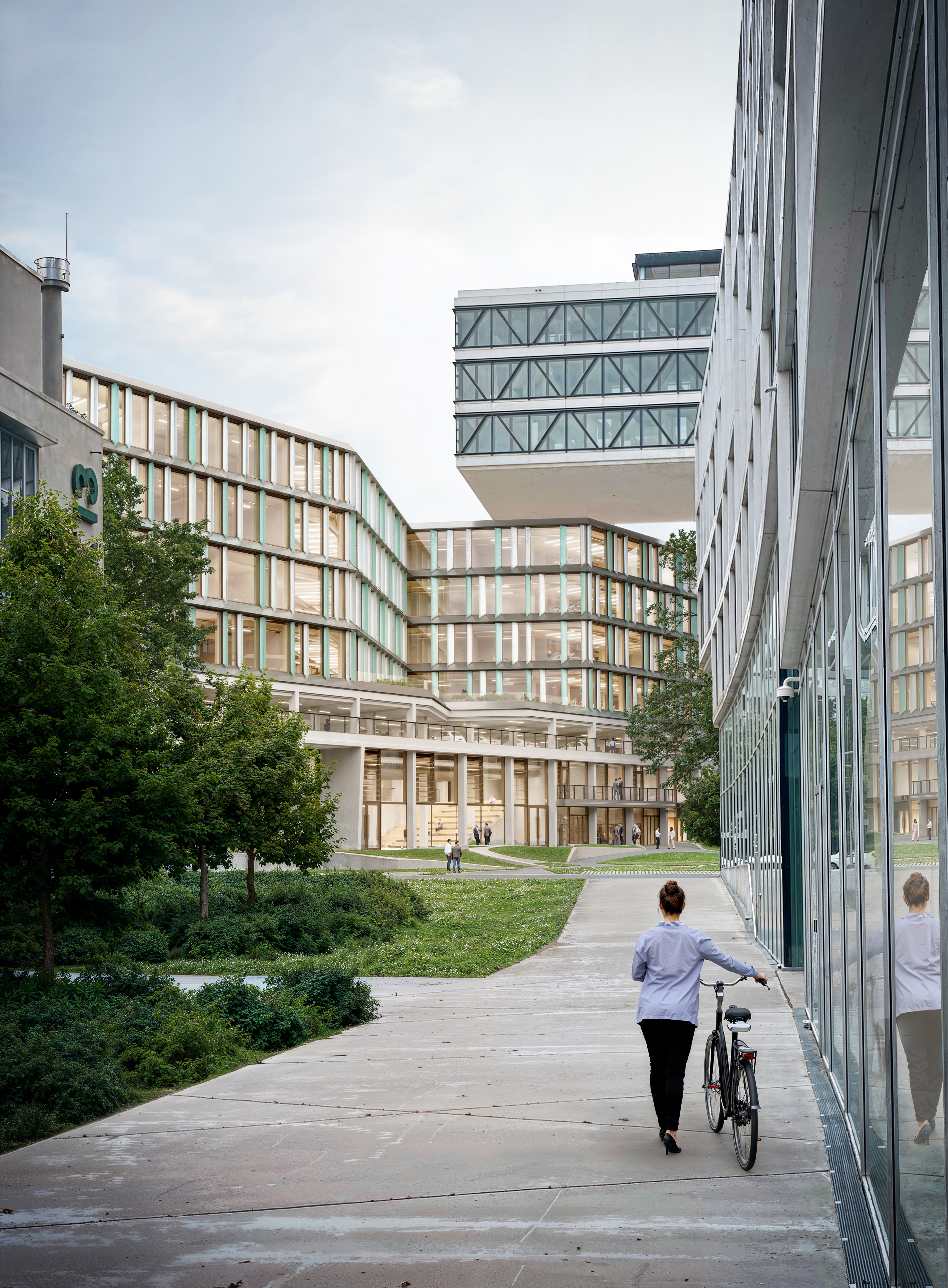 The picture shows an office building with a person and a bicycle