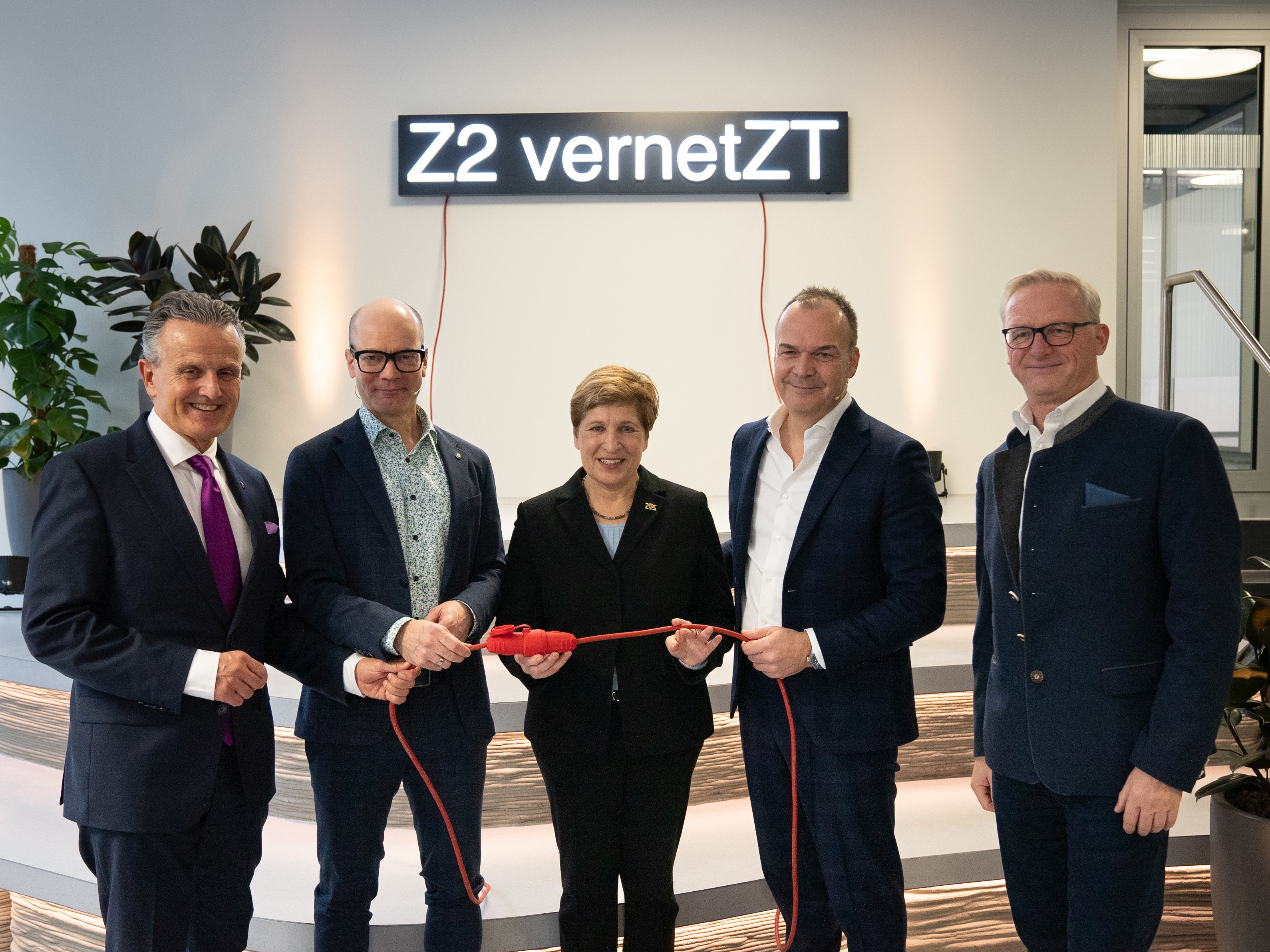 The picture shows five people standing in front of a light installation