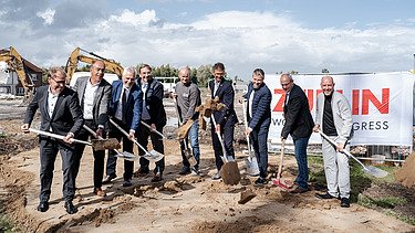 The picture shows people with shovels at the ground-breaking ceremony.
