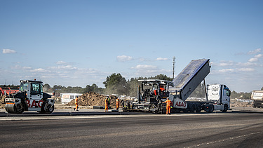 Construction includes the installation of 240,000 m² of asphalt and 110,000 m² of concrete.