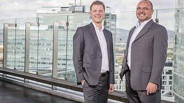 Photo of two people standing on a terrace