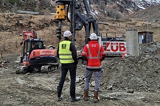 Two people looking at a building site