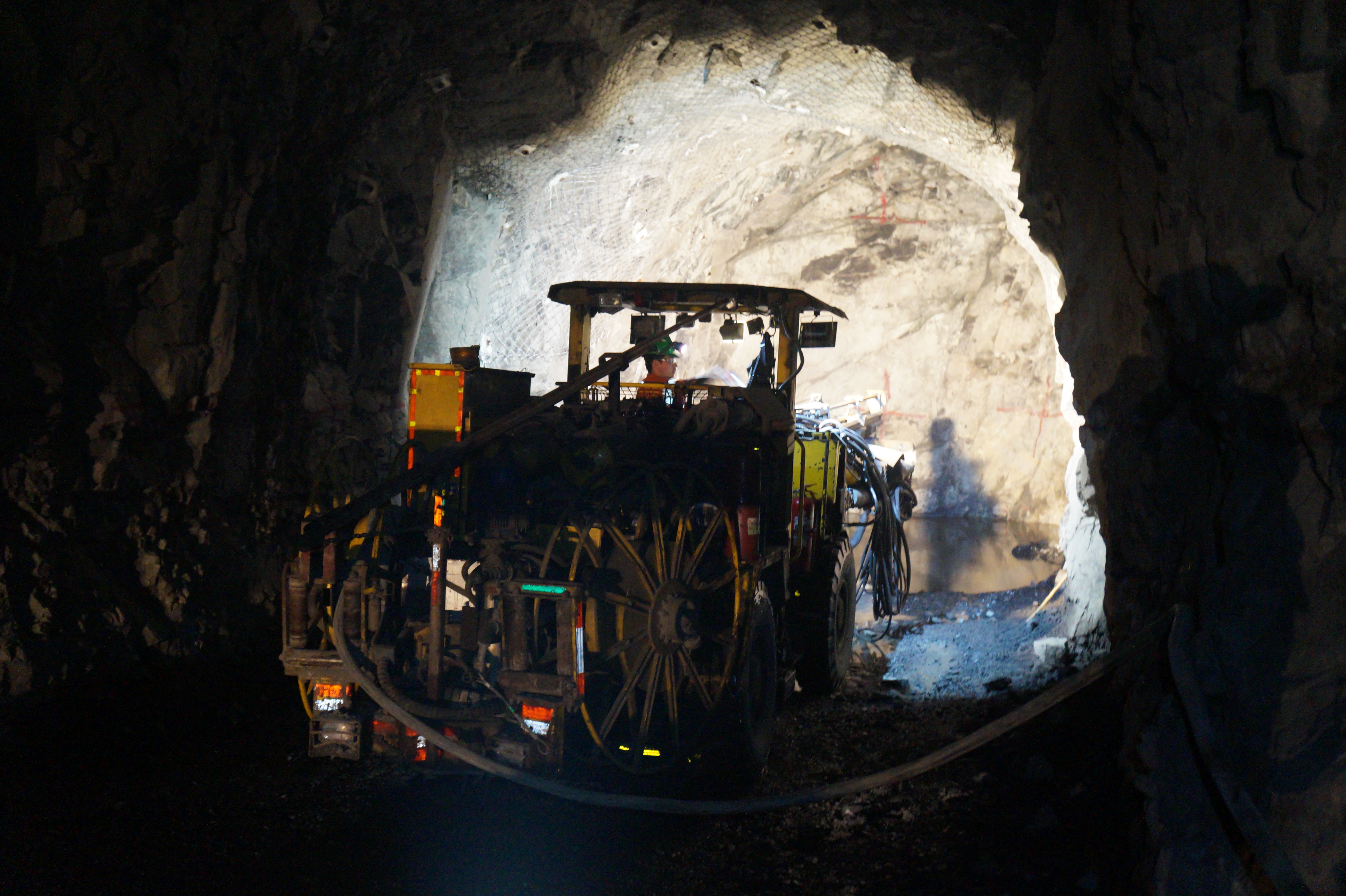 Photo shows an excavator at work in a tunnel tube