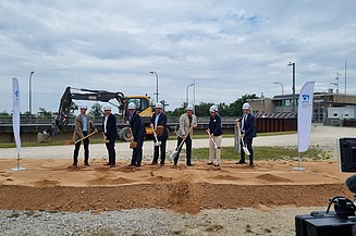 Seven men each hold a spade