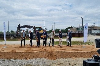 Seven men each hold a spade