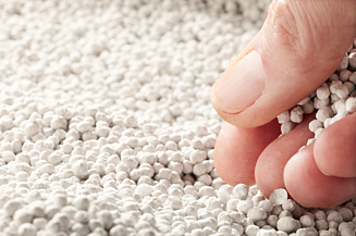 Photo of Polyhalite fertilizer and a hand