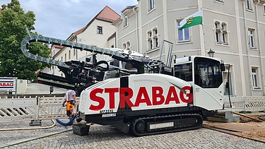 Photo of a machine carrying out civil engineering work in a square