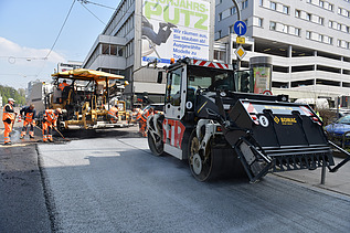 Foto von zwei Straßenbaumaschinen auf einer neuen Straße