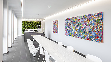 Foto einer Teeküche mit bunten Bildern an der Wand.