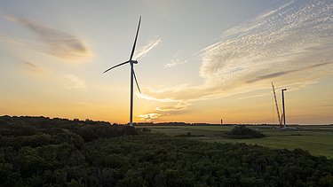 Deleni wind turbines in the light of the sunset