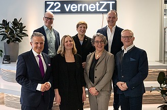 Das Bild zeigt fünf Personen, die vor einer Lichtinstallation stehen