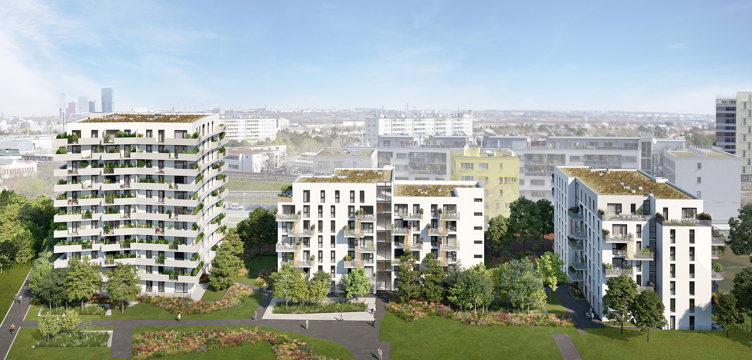 Photo of several new residential buildings, in front of a green meadow
