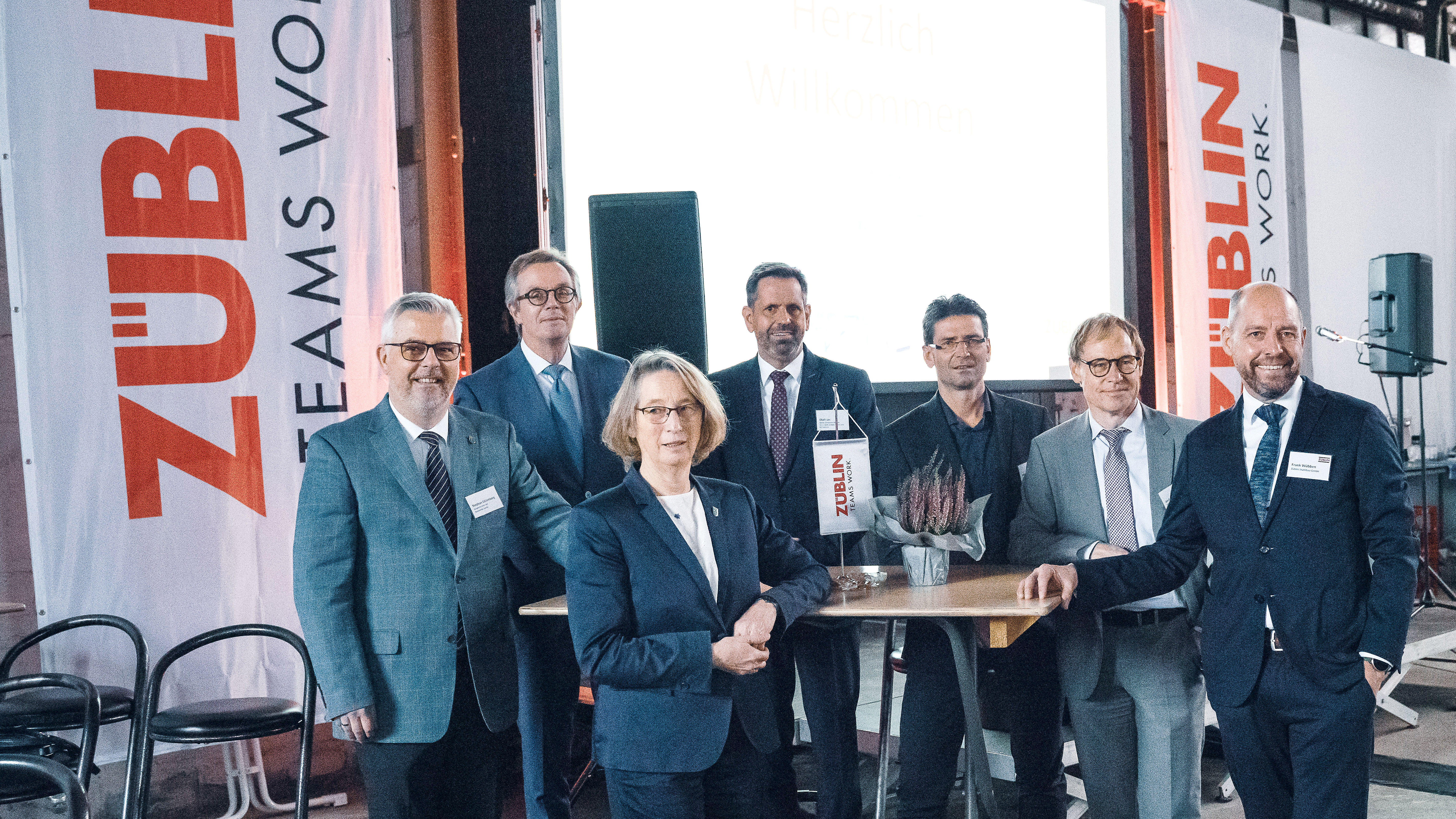 Foto von mehreren glücklich schauenden Personen bei der Jubiläumsfeier am Standort Sande.