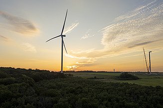Deleni wind turbines in the light of the sunset