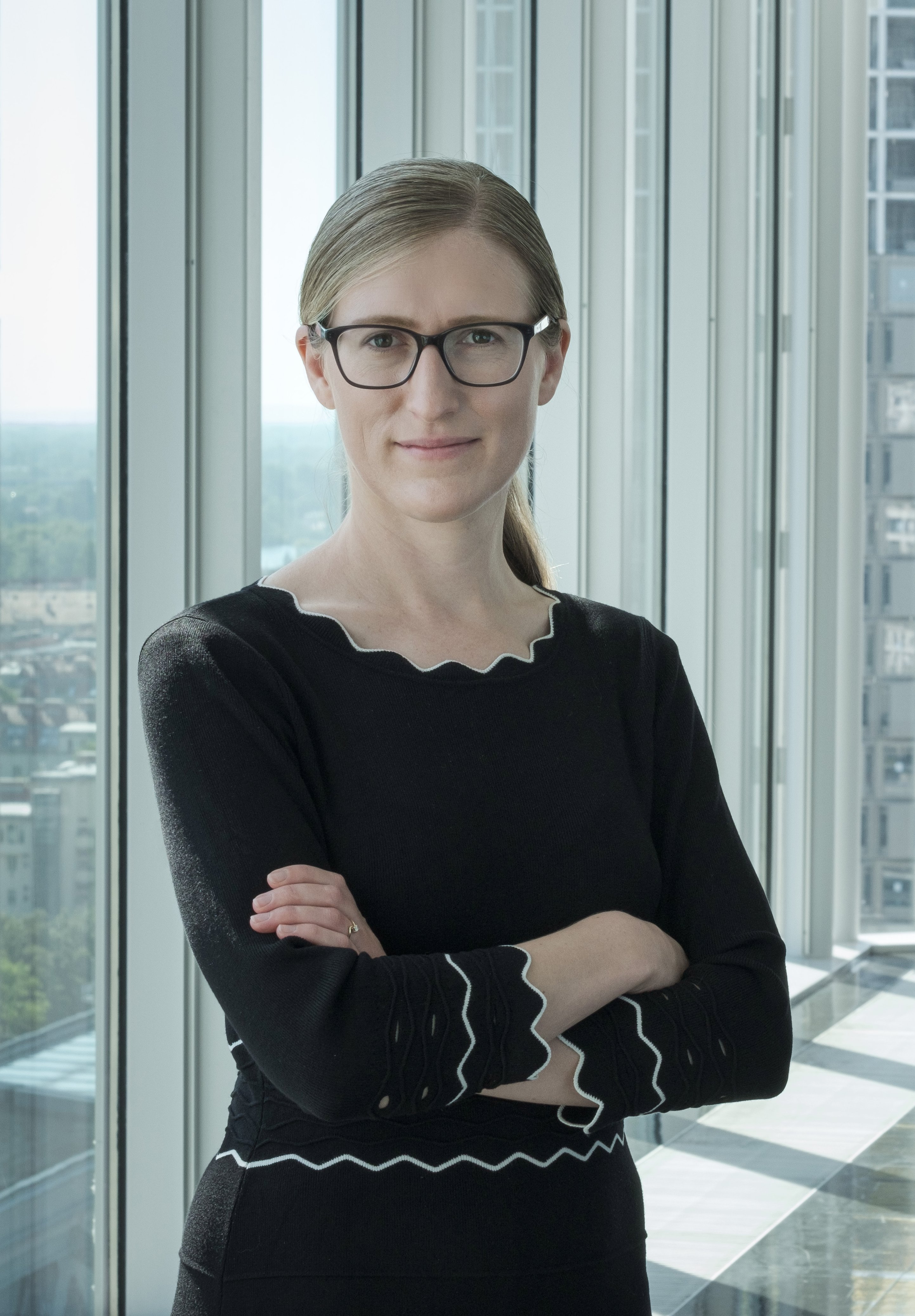 Photo of Marianne Jakl standing in front of a window