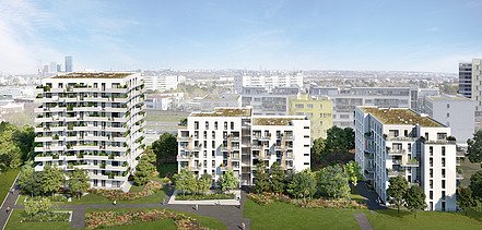 Photo of several new residential buildings, in front of a green meadow