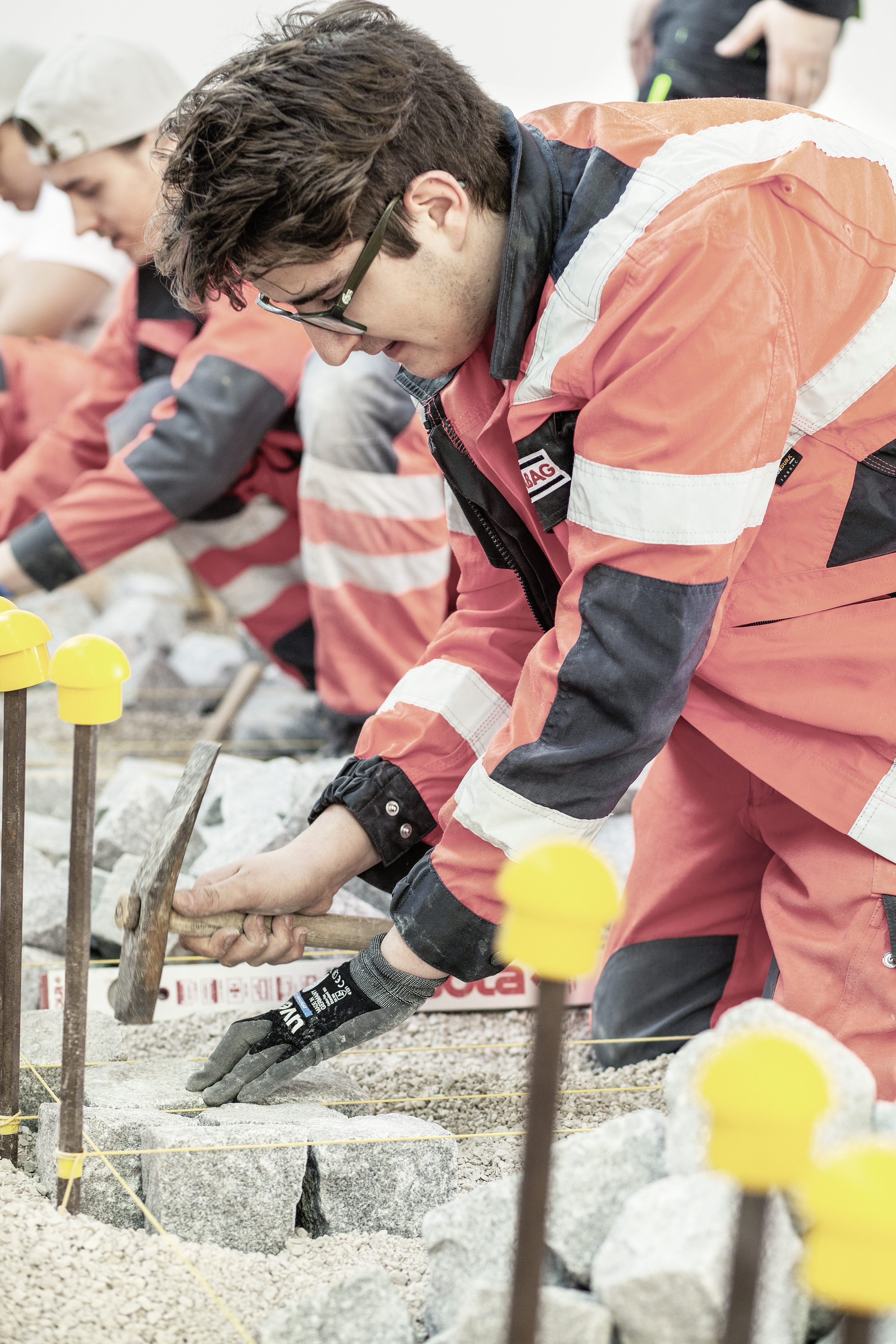 The picture shows two people in work clothes at work