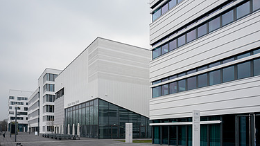 Foto von einem weißen Bürogebäude mit Blick von der Straße.      
