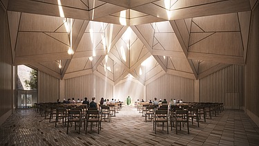 The picture shows a brightly lit interior with wooden walls