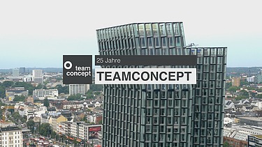 Foto von Bürogebäude mit einer Bauchbinde von „teamconcept – 25 Jahre