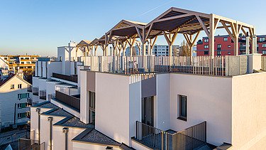 The roofs feature inviting pergolas and extensive greenery. 