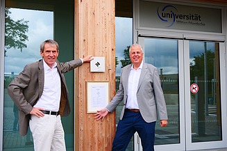 Foto von zwei Männern die freundlich schauen.   