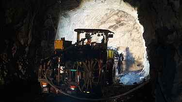 Foto zeigt einen Bagger in einer Tunnelröhre bei der Arbeit