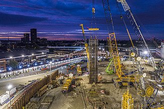 Construction site with cranes at night