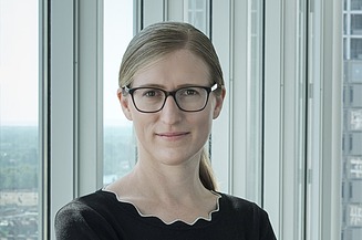 Photo of Marianne Jakl standing in front of a window
