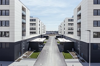 Visualisierung vom IN-Campus mit vier symmetrisch angeordnete Gebäudemodule in U-Form, mit Blick zwischen den Gebäuden. 