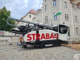 Photo of a machine carrying out civil engineering work in a square