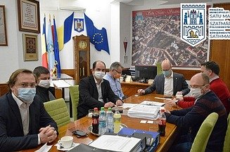 Foto von mehreren Personen bei einer Vertragsunterzeichnung unter Einhaltung der aktuell strengen Hygienevorschriften