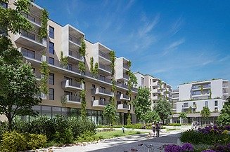 Photo of new buildings with green space and blue sky