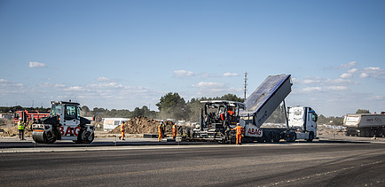Construction includes the installation of 240,000 m² of asphalt and 110,000 m² of concrete.