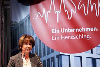 Foto von der Oberbürgermeisterin von Köln, die vor einem Pullt steht und eine Rede hält.  