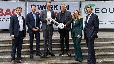 Photo of six people standing at the symbolic handover of the construction site