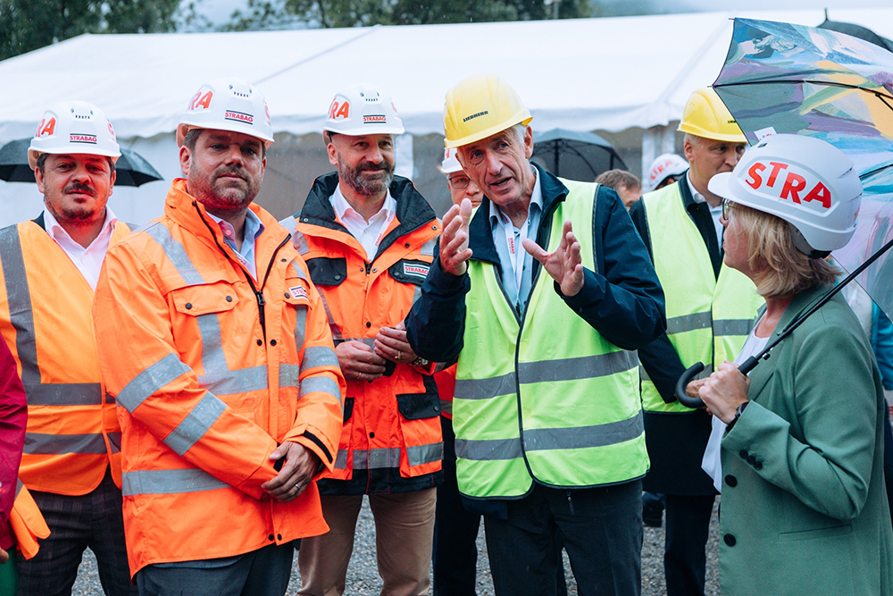 Photo of several people wearing construction helmets and protective jackets