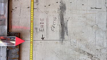 Concrete pillar with a tape measure
