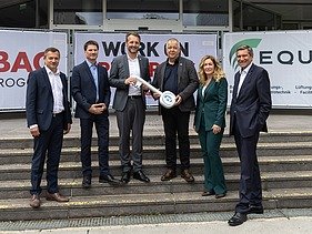 Photo of six people standing at the symbolic handover of the construction site