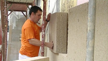 Photo of a craftsman laying wall panels