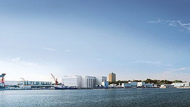 Photo of a harbor area by the sea, with blue sky