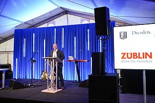 Foto von einer Rede von einem Mann in Anzug. 