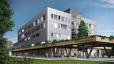 Photo of a modern four-story building under a blue sky