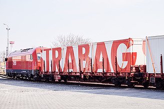 Photo shows a railway wagon loaded with STRABAG containers