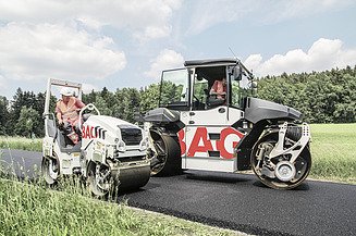Subject traffic route construction Two construction machines with STRABAG lettering can be seen paving a road after it has been tarred.