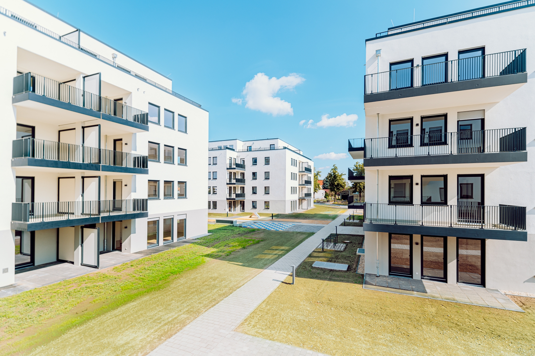 Visualisierung von einem Wohnpark, mit mehreren Gebäuden.  