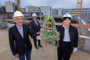 Foto von mehreren Personen beim Halten des Richtkranzes. 
