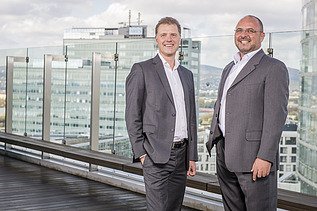 Photo of two people standing on a terrace