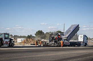 Construction includes the installation of 240,000 m² of asphalt and 110,000 m² of concrete.