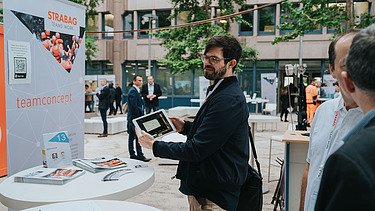 Foto von mehreren Personen im Freien vor einem Bürogebäude